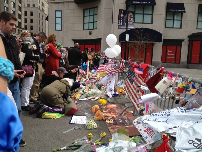 Flowers and people at barricade on Boylston Street